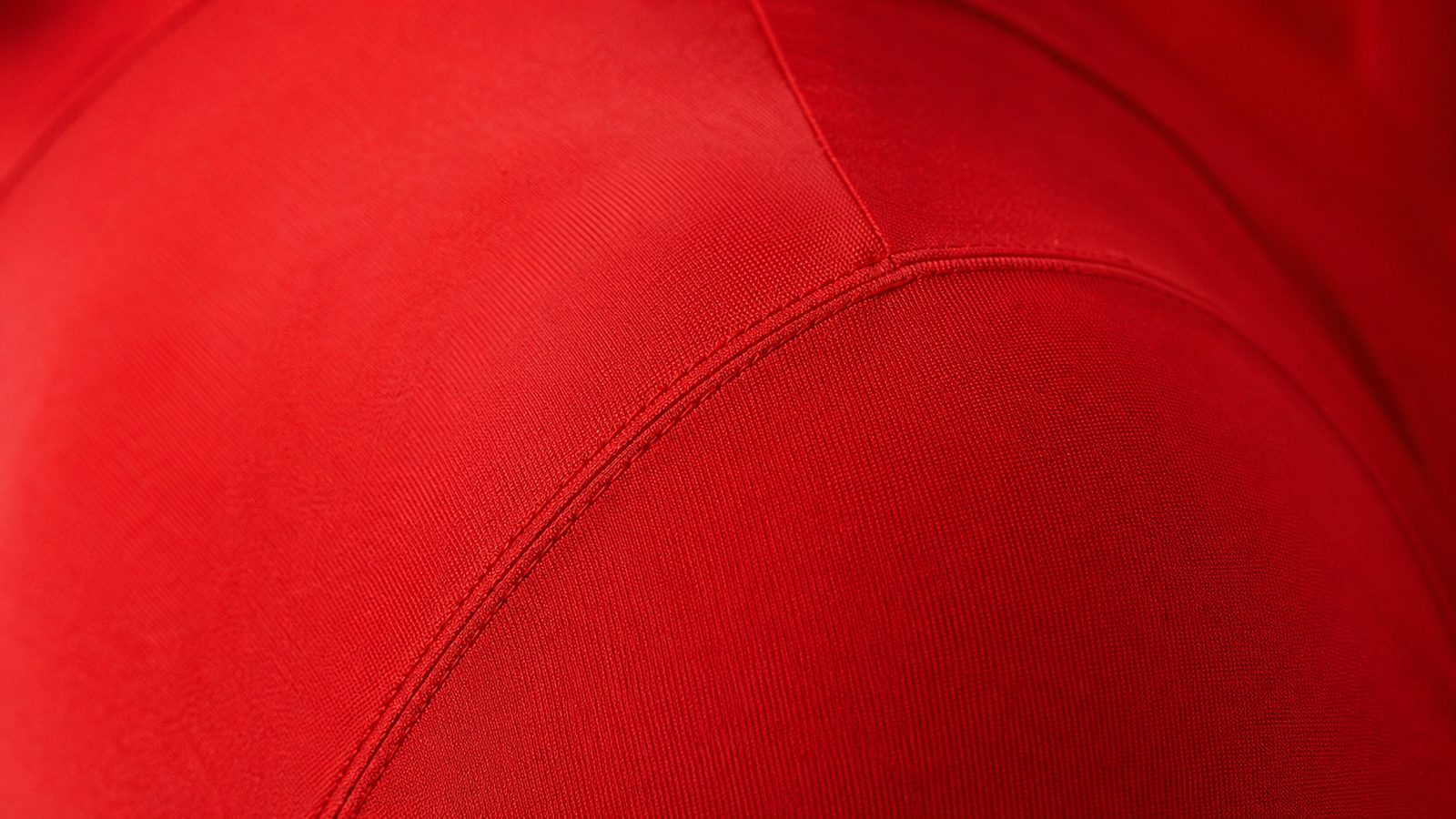 Close-up of a solid-colour Morphsuit fabric stretched taut over a shoulder, showing the fine four-way-stretch breathable spandex weave