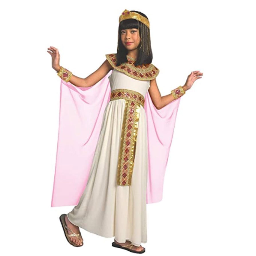 Girls Pink Cleopatra costume: cream sleeveless dress with a gold jewelled collar, pale pink cape panels, gold gem headband, jewelled belt sash, and gold wrist cuffs