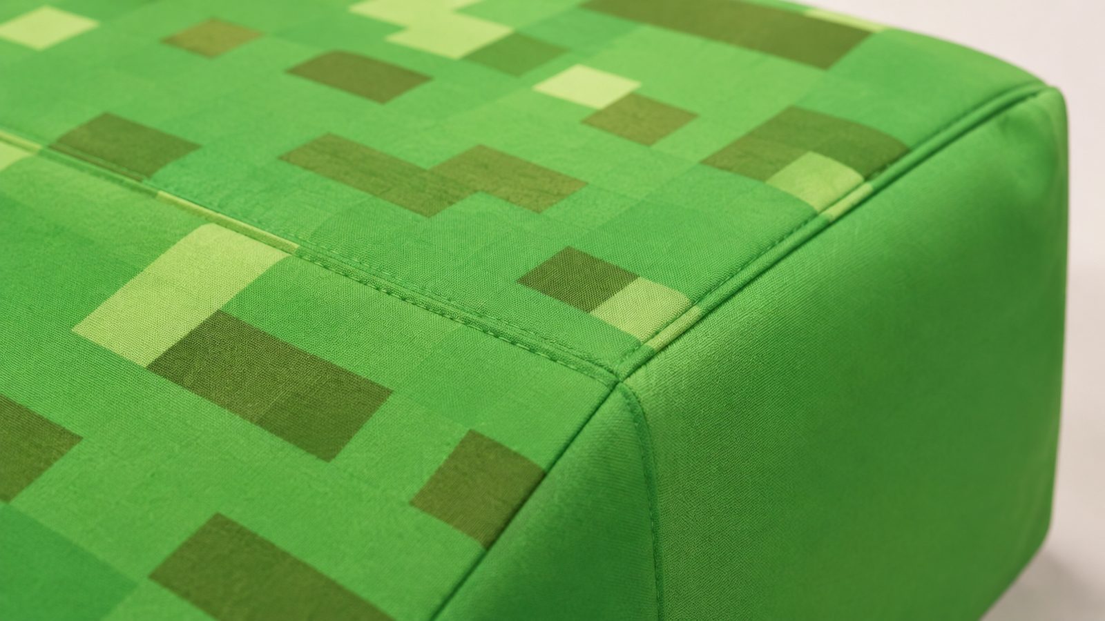 Close-up detail of a 3D constructed Minecraft costume tunic, showing the blocky, pixelated texture and stitched construction up close