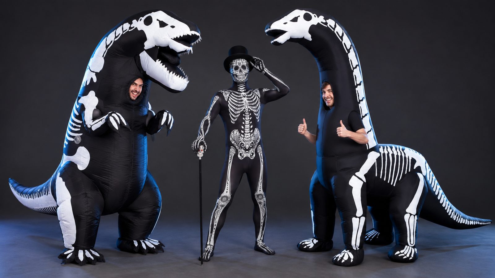 A skeleton crew of a Day of the Dead skeleton Morphsuit, an inflatable skeleton T-rex costume and an inflatable skeleton diplodocus costume posed together