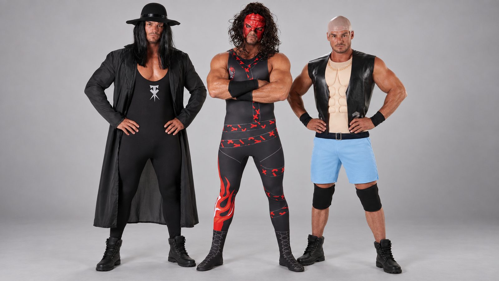 Three men in WWE Undertaker, Kane and Stone Cold Steve Austin costumes standing together as a wrestling trio