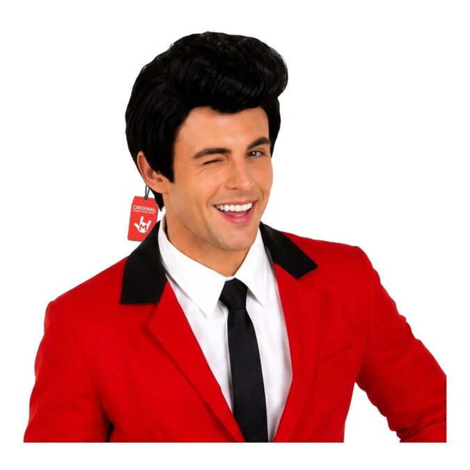Smiling man wearing a black 1950s-style quiff wig with a high, swept-back top, styled with a red jacket, white shirt and black tie