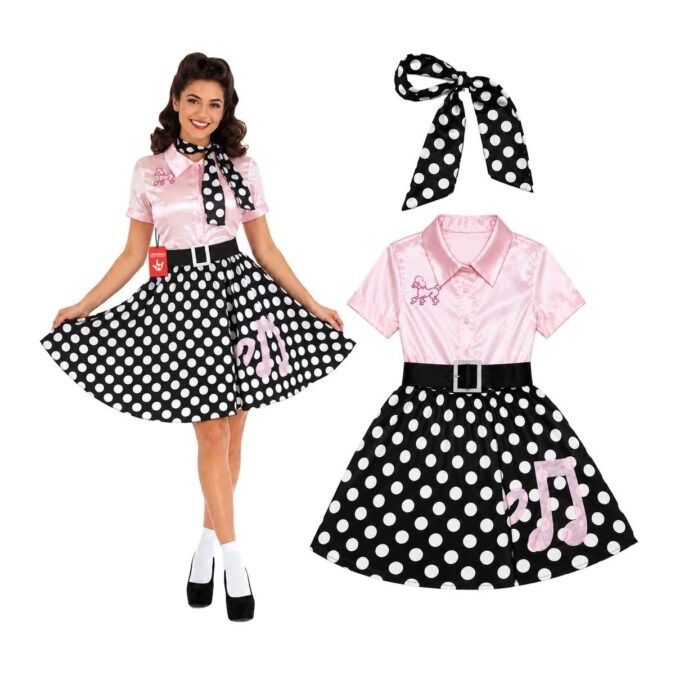 Woman in a 50s poodle dress costume: pink satin bodice with a poodle motif, black belt, black and white polka dot skirt and a matching spotted scarf