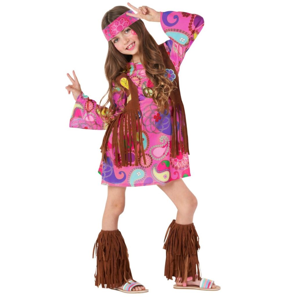 Girl in a pink 60s hippie costume with printed dress, brown fringed vest, headband and fringed leg warmers