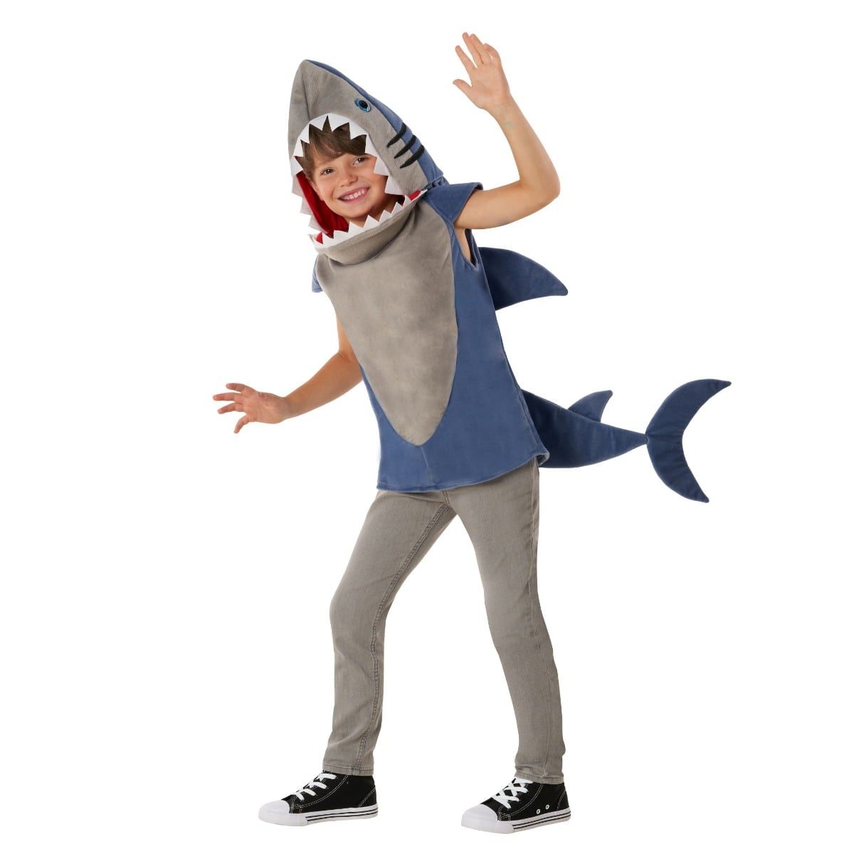 Boy wearing a gray and blue shark tabard costume with an integrated open-mouth shark head over his own jeans and sneakers, face left uncovered