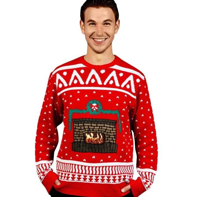 A red knitted Christmas sweater with a white nordic snowflake and tree pattern, and a brick fireplace with orange flames knitted into the center front panel