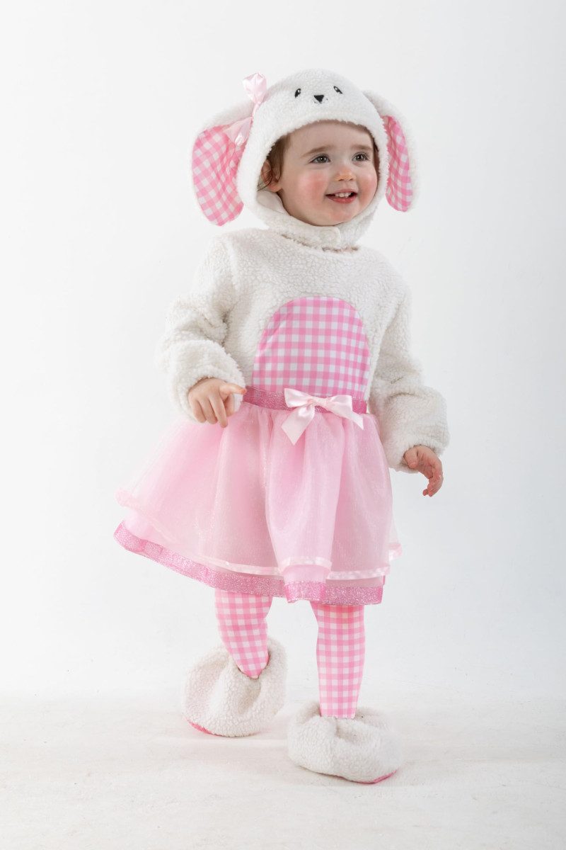 Toddler wearing a plush lamb costume with a tutu-style skirt, a hood with gingham ears, leggings, and booties
