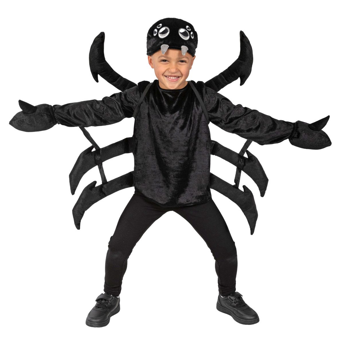 Smiling child in a black velour spider costume with stuffed spider legs on a backpack, a spider hat with eyes and fangs, and black gloves
