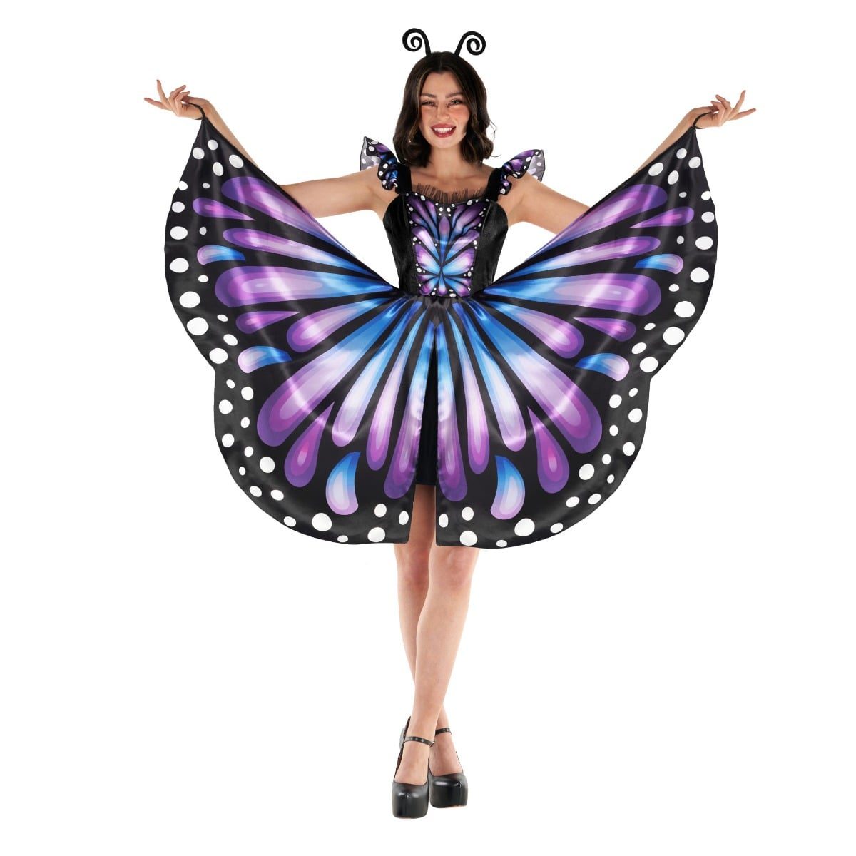 Smiling woman in a short black velour-bodice dress with a printed purple and blue butterfly-wing skirt, held out with elastic finger loops, and a black antenna headband