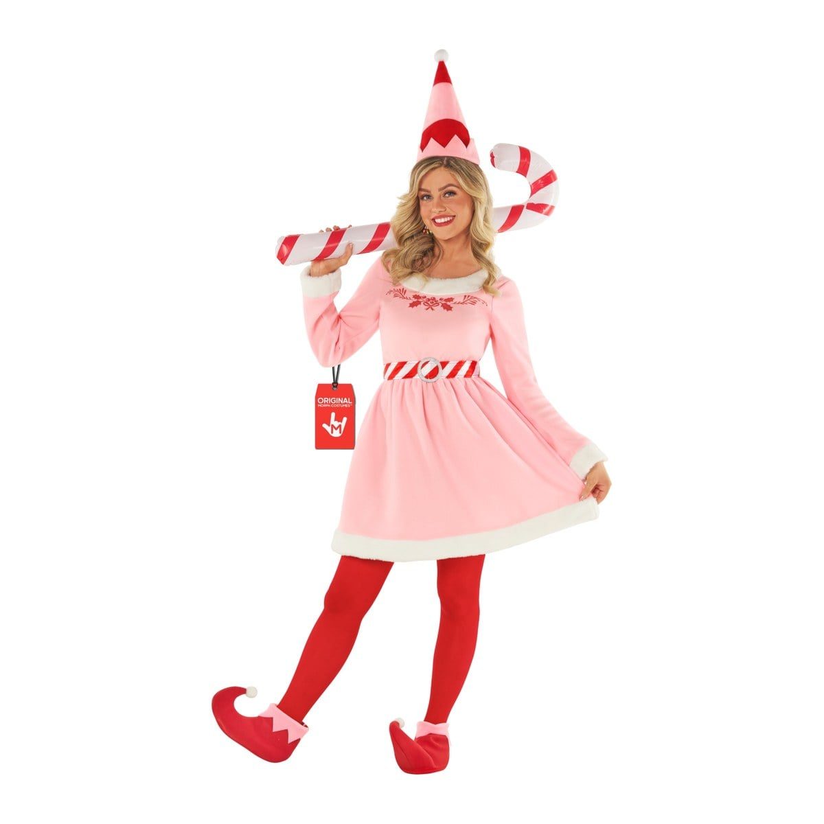 Woman in a pink elf skater dress with white faux fur trim, a red print across the chest, a red-and-white striped belt, red tights, red curled elf boot covers, and a pink and red pointed hat
